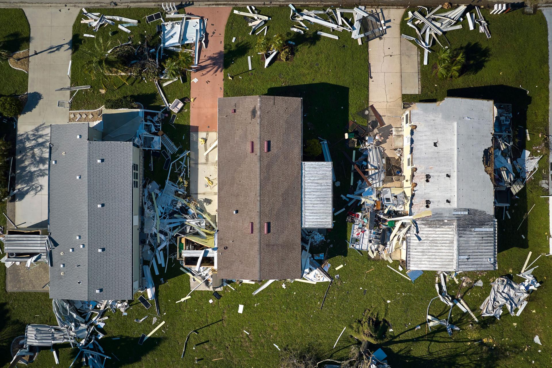 Hurricane Ian destroyed homes in Florida residential area. Natural disaster and its consequences